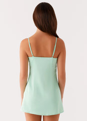 Sage green strapless mini dress with bead embellishments